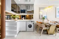 1 Bedroom Condo for Sale at The Riviera Malibu modern kitchen with white cabinets, microwave, and washing machine.