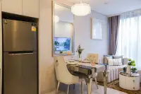 1 Bedroom Condo for Sale at Copacabana Coral Reef open-plan dining area with stainless steel fridge, crystal chandelier, and plush sofa