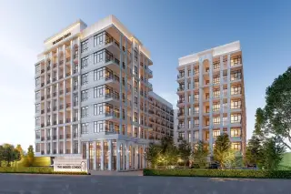 The Indeed Condo Pattaya white multi-storey exterior facade with balconies and illuminated entrance at dusk