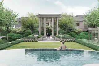 Patta Terrane communal pool with woman swimming, manicured lawn, columned pergola entrance, and flowering garden borders