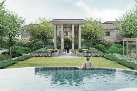 Patta Terrane communal pool with woman swimming, manicured lawn, columned pergola entrance, and flowering garden borders