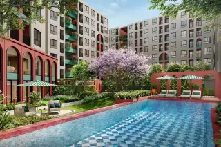 D Condo Vite outdoor swimming pool with blue mosaic tiles, sun loungers, umbrellas, and lush tropical garden courtyard