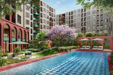 D Condo Vite outdoor swimming pool with blue mosaic tiles, sun loungers, umbrellas, and lush tropical garden courtyard