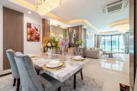 3 Bedroom House for Sale & Rent at PCK Villa elegant dining area with marble table, velvet chairs, crystal chandelier and open living room