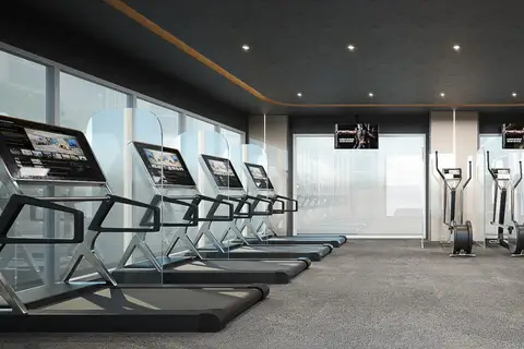 The Coral Pattaya, modern fitness center with treadmills, ellipticals, and large windows.