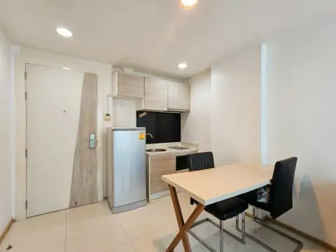 1 Bedroom Condo for Sale at Acqua Condo compact kitchenette with fridge and dining table near entrance