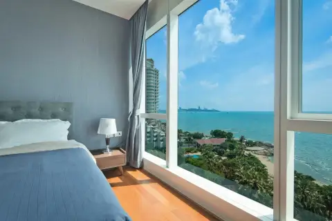1 Bedroom Condo for Sale & Rent at Palm Wongamat bedroom with floor-to-ceiling windows overlooking coastline