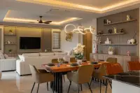 3 Bedroom House for Sale at Zensiri Lakeside Pool Villas dining area with wood live-edge table, designer pendant light, and TV lounge