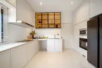 4 Bedroom House for Sale at Chieftain modern kitchen with white cabinetry, marble countertops, and glass display cabinets