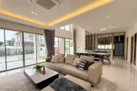 3 Bedroom House for Rent at Horizon By Patta bright living room with beige sectional sofa, coffered ceiling, and floor-to-ceiling sliding doors