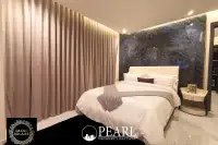2 Bedroom Condo for Sale in Grand Solaire Pattaya master bedroom with king-size bed and city view