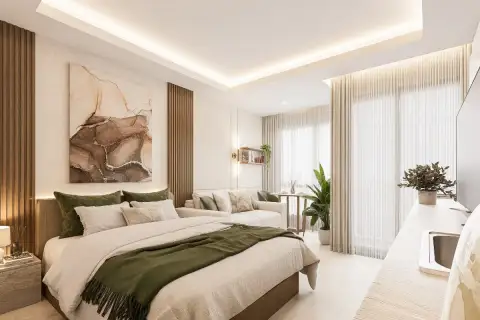 Studio Condo for Sale at Siam Oriental Beach: Bright studio interior with a bed, sofa, and sheer curtains by the window.