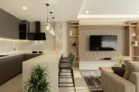 3 Bedroom Condo for Sale at Zensiri Estates and Residences modern kitchen with dark grey cabinets, marble backsplash, and bar counter stools