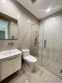 2 Bedroom Condo for Sale at Reflection Jomtien Beach modern bathroom with glass shower and toilet