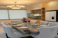 4 Bedroom House for Sale at Paradise Villa 1 & 2 elegant dining area with marble table, tufted chairs, and gold chandelier