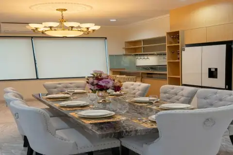 4 Bedroom House for Sale at Paradise Villa 1 & 2 elegant dining area with marble table, tufted chairs, and gold chandelier
