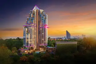 The Riviera Santa Monica modern high-rise building with purple accent lighting against a vibrant sunset sky.
