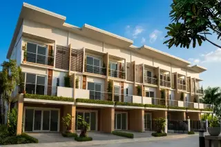 Supalai Ville Thepprasit 8 entrance with security booth, barrier, lush landscaping, and residential buildings.
