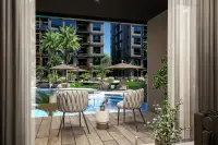 3 Bedroom Condo for Sale at Zenith 2: Stylish bedroom with a large bed, TV console, and window overlooking lush greenery.