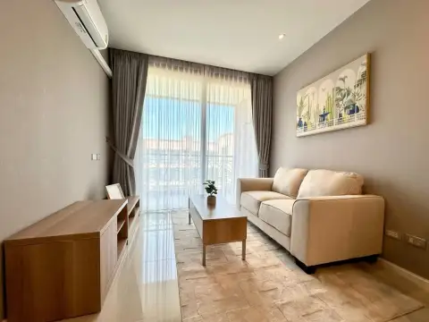 1 Bedroom Condo for Sale at Atlantis Condo Resort living area with sofa, coffee table and sheer curtains