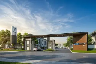 Lio Pattaya Klang modern entrance gate with security booth, a car, and residential townhouses in the background.