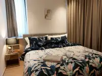 2 Bedroom Condo for Sale at EDGE Central Pattaya bedroom with floral bedding and bedside lamp