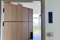 1 Bedroom Condo for Sale at The Twin Tower Jomtien Beach Pattaya wooden front door with unit number 1341 and city view beyond