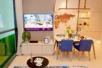 1 Bedroom Condo for Sale at Once Wong Amat living and dining area with wall-mounted TV and world map feature wall