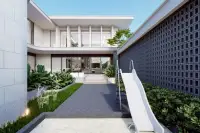 5 Bedroom House for Sale at Gravity Prime Pattaya side yard with a white slide and modern house exterior.