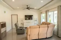 3 Bedroom House for Sale at Siam Executive Estate living room with reclining sofas, TV and ceiling fan
