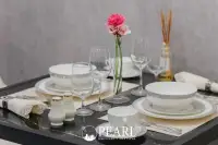 1 Bedroom Condo for Sale at Grand Solaire Pattaya: Close-up of dining table set with white dishes, glasses, and pink flowers.