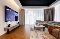 5 Bedroom House for Rent at Casa Jomtien: Living room with large TV, L-shaped sofa, and starry ceiling.