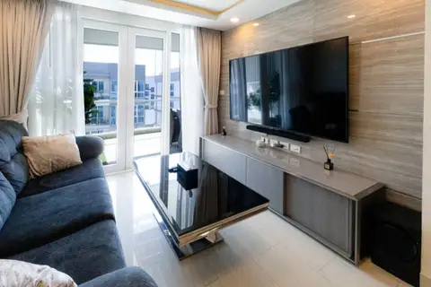 2 Bedroom Condo for Sale at Grand Avenue Residence: Living room with sofa, coffee table, TV, and balcony access.