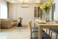 3 Bedroom House for Sale at Phonthep Garden Ville 2 open-plan dining and living area with wood dining table and gold chandelier