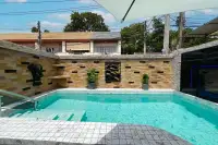 3 Bedroom House for Sale in Bang Lamung turquoise private swimming pool with stone wall, golden wall art and elephant statue