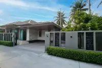 3 Bedroom House for Sale at Amarin House 2 modern exterior with covered carport, gated entrance, and tropical landscaping