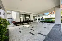 4 Bedroom House for Sale & Rent in Bang Lamung spacious covered driveway area with tiled flooring leading to pool and garden