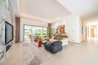6 Bedroom House for Sale in Huai Yai spacious living room with marble TV wall tray ceiling and garden view