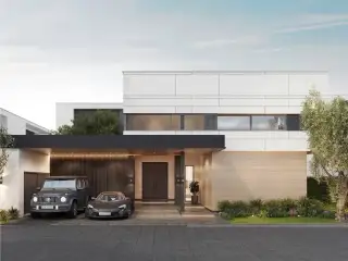 Manruetra Pura Pattaya front exterior of a modern house with covered parking and wooden accents under a bright sky.