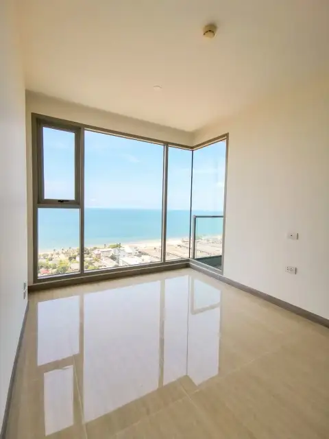 1 Bedroom Condo for Sale at The Riviera Jomtien empty room with floor-to-ceiling windows overlooking sea view