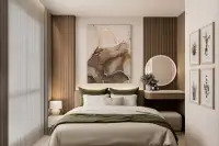 1 Bedroom Condo for Sale at Siam Oriental Beach: Cozy bedroom with a large bed, abstract art, and a vanity table.