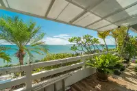 2 Bedroom Condo for Sale at Grand Condotel covered timber deck with white railing, tropical plants, and direct sea view