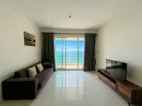1 Bedroom Condo for Sale at Reflection Jomtien Beach living room with balcony and panoramic ocean view
