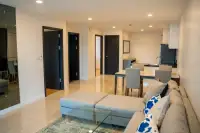 2 Bedroom Condo for Sale at The Elegance spacious living and dining area with tiled floors and dark bedroom doors