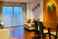 2 Bedroom Condo for Sale at The Senate Residences bright living room with sofa, dining table, and panoramic balcony sea view