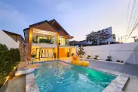 5 Bedroom House for Sale in Bang Lamung, exterior with swimming pool and inflatable duck at sunset.