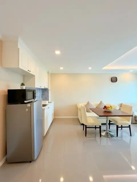 1 Bedroom Condo for Sale at The Orient Resort & Spa open kitchen with stainless fridge and dining table