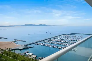 Ocean Portofino high-floor balcony with glass railing overlooking marina yacht basin and Gulf of Thailand