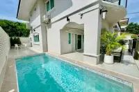 4 Bedroom House for Sale at Wonderland II two-storey white exterior with terracotta roof and wooden sliding gate