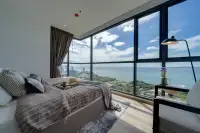 2 Bedroom Condo for Sale at Andromeda Condominium master bedroom with panoramic sea and city view through wraparound glass windows